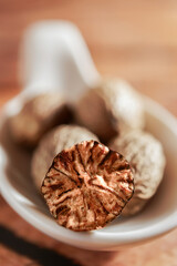 macro photograph of a halved nutmeg with out of focus background and copy space