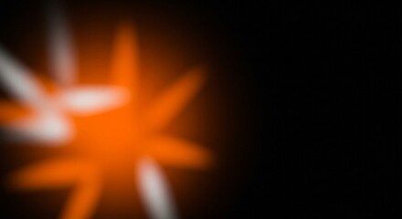 The blurred lines of orange and white light in this image form an abstract and dynamic composition, intersecting and overlapping against a dark background