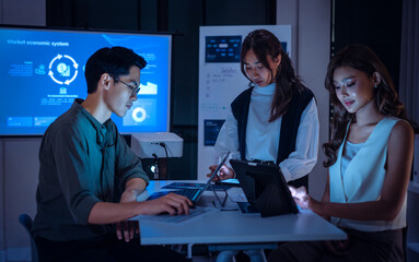 team of financial discussion budget planning, analyzing digital financial data and strategy in a modern office at night