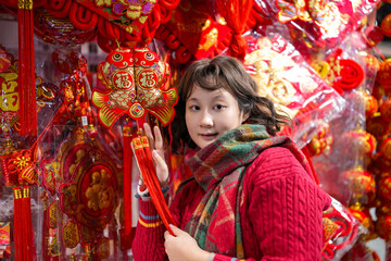 Young Woman Enjoying Colorful Lunar New Year Decorations in Vibrant Market