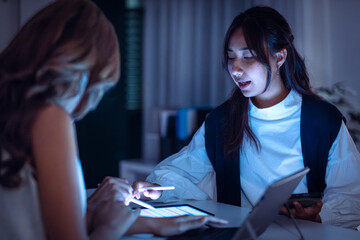 team of financial discussion budget planning, analyzing digital financial data and strategy in a modern office at night