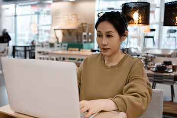 Young Woman Working on Laptop in Modern Caf�pace