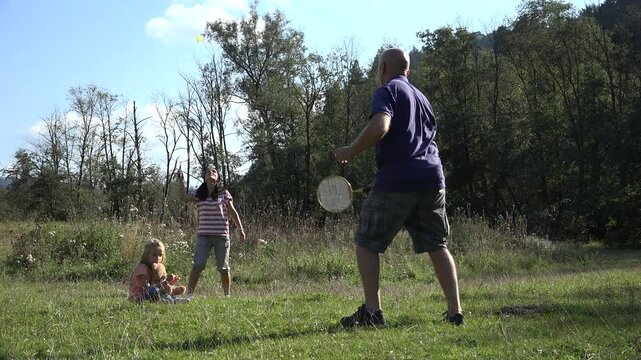 Mother, Father, Child, Girl Playing Badminton on Meadow , Family Making Spor