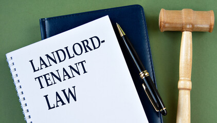 LANDLORD TENANT LAW - words on a white sheet with a judge's gavel