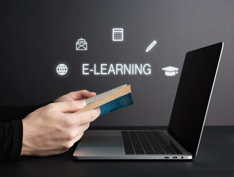 Student learning online with e-learning platform, reading a book and using laptop