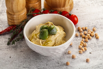 Tasty hummus with green olives