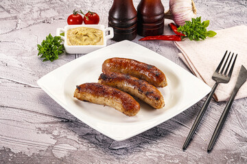 Delicous natural roasted sausages in the plate