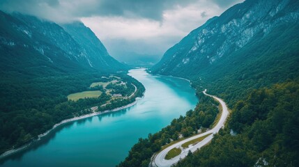 Aerial view of turquoise lake winding through mountains, scenic road. Travel, nature, landscape