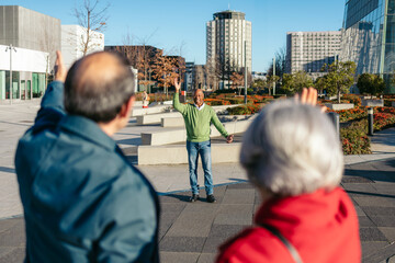 Fototapeta premium Three senior friends happily wave in a modern cityscape