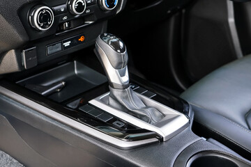 automatic transmission shift selector in the car interior. Closeup a manual shift of modern car gear shifter. 4x4 gear shift.