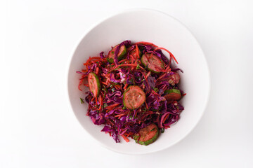 salad of cabbage, carrots and cucumbers. on a white background