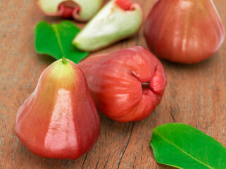 fresh red rose apples on wooden board