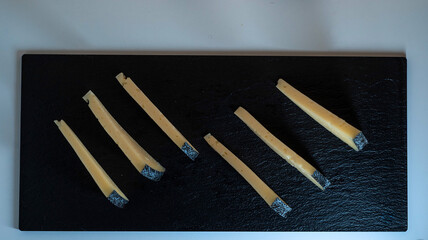 Varieties of artisanal cheese displayed on a slate board for a gourmet tasting experience
