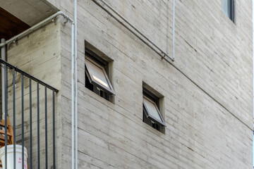 A collection of various exterior windows on buildings, showcasing diverse architectural styles and materials.