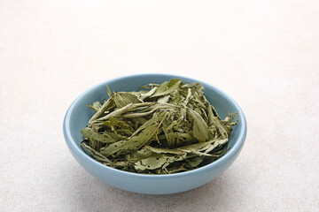 Stevia rebaudiana, dietary sweetener. Fresh and dried crushed stevia leaves. 
