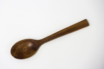 Dark wood spoon on white background