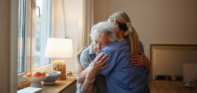 Psychologist, caregiver provides mental health support and grief counseling to elderly patient. Banner with copy space.