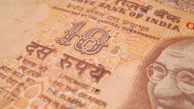  Close-up of an Indian 10-rupee banknote with sliding motion