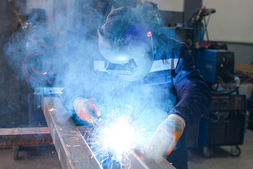 High-precision metal machining and welding process in an industrial workshop, including lathe...
