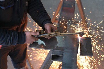 Industrial Metalworking Process: Precision Cutting, Welding, and Grinding Operations in a Manufacturing Facility