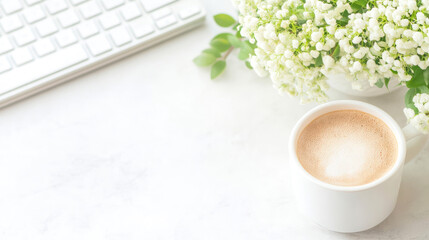 Minimal workspace with coffee cup and white flowers creating a calm productive atmosphere on light background
