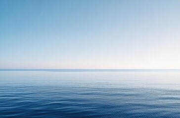 Obraz premium Serene Blue Ocean Under Clear Sky with Gentle Waves Creating a Tranquil Atmosphere 