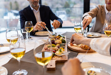 Close up of peoples hands in restaurant taking meal during the lunch.