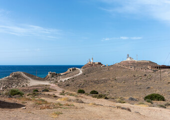 lighthouse and other buildings on the cliff's edge