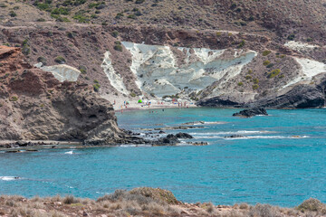 steep beach in the middle of a volcanic landscape