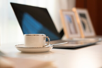 Laptop and coffee on a desk in an office or home workspace