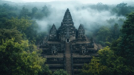 A mystical wide-angle view of an ancient temple surrounded by layers of mist and dense tropical greenery for a mysterious travel vibe