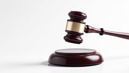 Judge's gavel hovering over sound block on white background