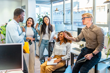 Multi ethnic business team sharing ideas in coworking office space