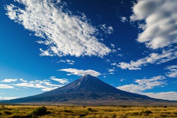 Fototapeta premium Mount Fuji rises majestically above clouds during sunrise in Japan, showcasing a breathtaking landscape