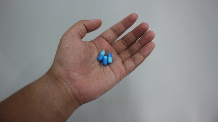 hand holding medicine capsule