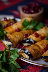 eggplant rolls stuffed with spicy pasta with nuts.