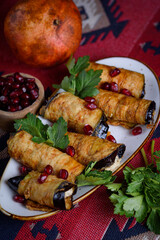 eggplant rolls stuffed with spicy pasta with nuts.
