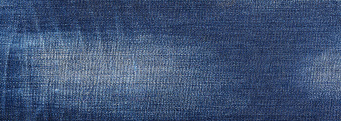 Denim fabric texture showcasing subtle variations in blue tones under bright light in a studio setting