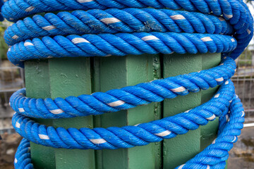 Close Up of Textured Blue Rope Tied to Steel Plate Constructions.