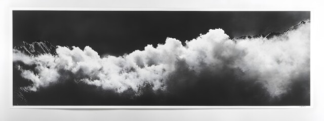 A black and white photograph of the Andes Mountains in clouds
