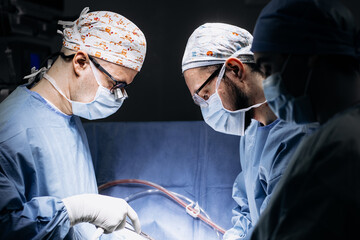 A team of professional surgeons performs surgery in a modern hospital. Concept skills working using...
