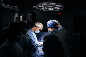 A team of professional surgeons performs surgery in a modern hospital. Concept skills working using...