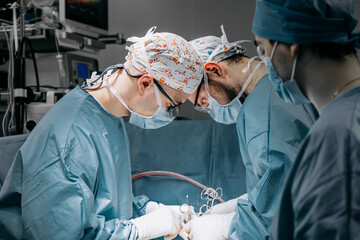 A team of professional surgeons performs surgery in a modern hospital. Concept skills working using...