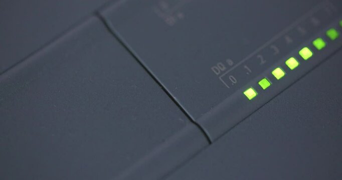 Close-up of a PLC blinking output indicator lights.