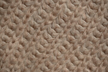 brown wool texture of acrylic knitted fabric, texture of knitted light brown sweater, close-up texture of beige knitted fabric, macro texture of tan knitted woolen clothes	
