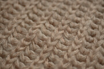 brown wool texture of acrylic knitted fabric, texture of knitted light brown sweater, close-up texture of beige knitted fabric, macro texture of tan knitted woolen clothes	
