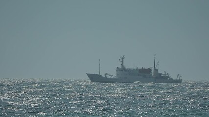 Ship Ocean Foggy Weather - A large, gray ship sails through the ocean on a foggy day. The vessel's silhouette is barely visible against the hazy background.