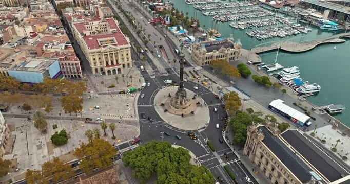 Aerial view Placa de les Drassanes of Barcelona. Traffic on the embankment of Catalonia, boats moored in the port, cars on the highway in Spain. High quality 4k footage