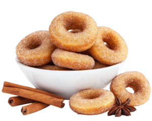 Warm and comforting mini doughnuts covered in cinnamon sugar, served in bowl with cinnamon sticks and star anise, perfect for sweet treat