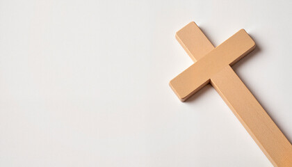 Obraz premium Minimalistic wooden cross on clean white background symbolizing faith and devotion